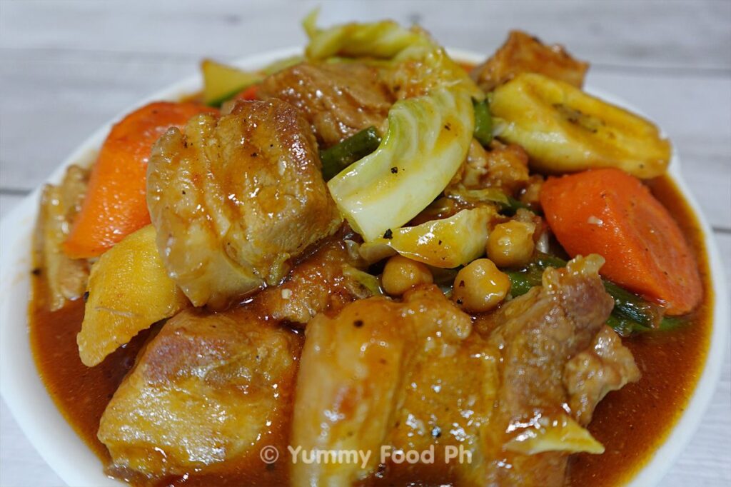 Pork Pochero recipe stew with bananas and chorizo simmering in a pot